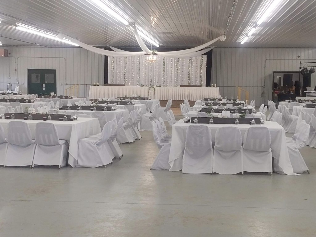 Tables and chairs covered with white linens